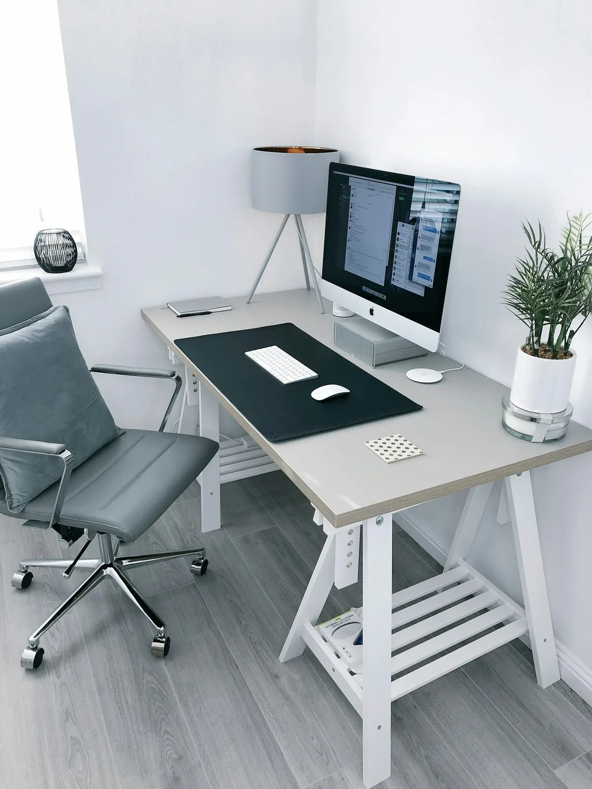 gray leather office rolling armchair beside white wooden computer desk