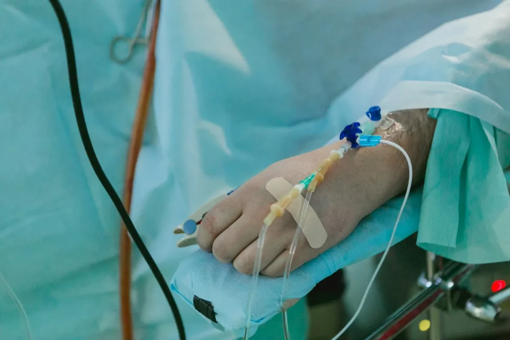 A person in a hospital bed with an IV
