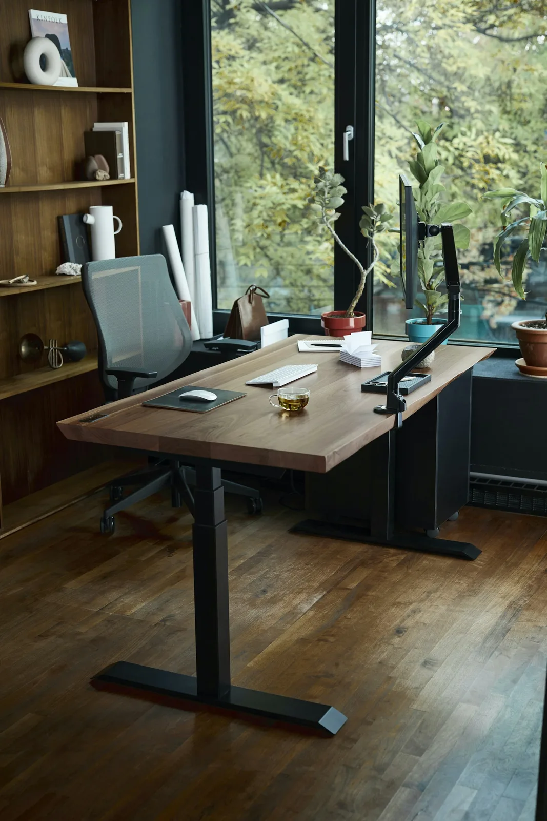 A desk with a laptop in front of a window