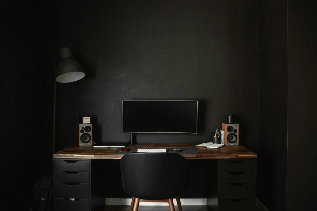 A desk with a computer on top of it