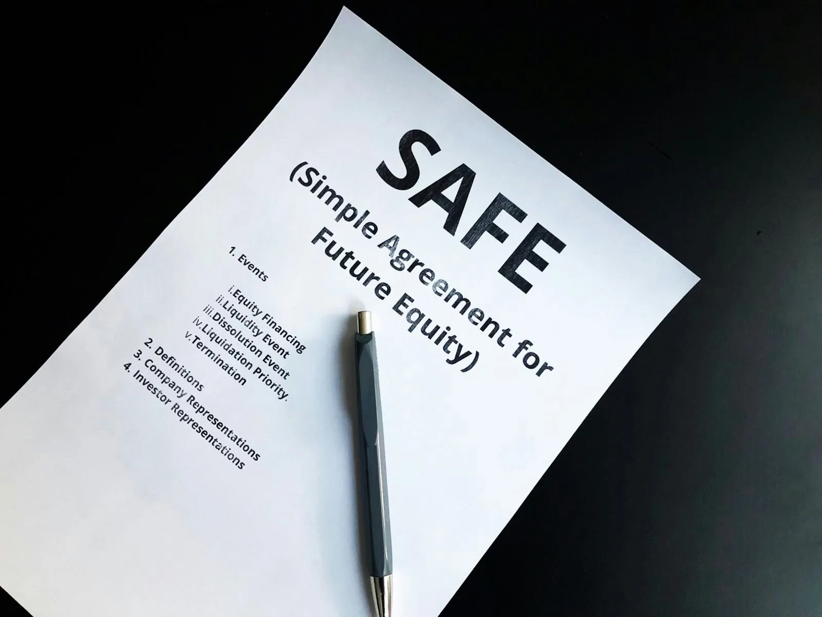 a pen sitting on top of a piece of paper