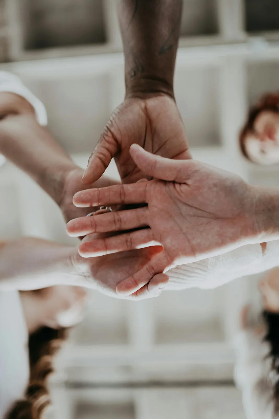 a group of people putting their hands together
