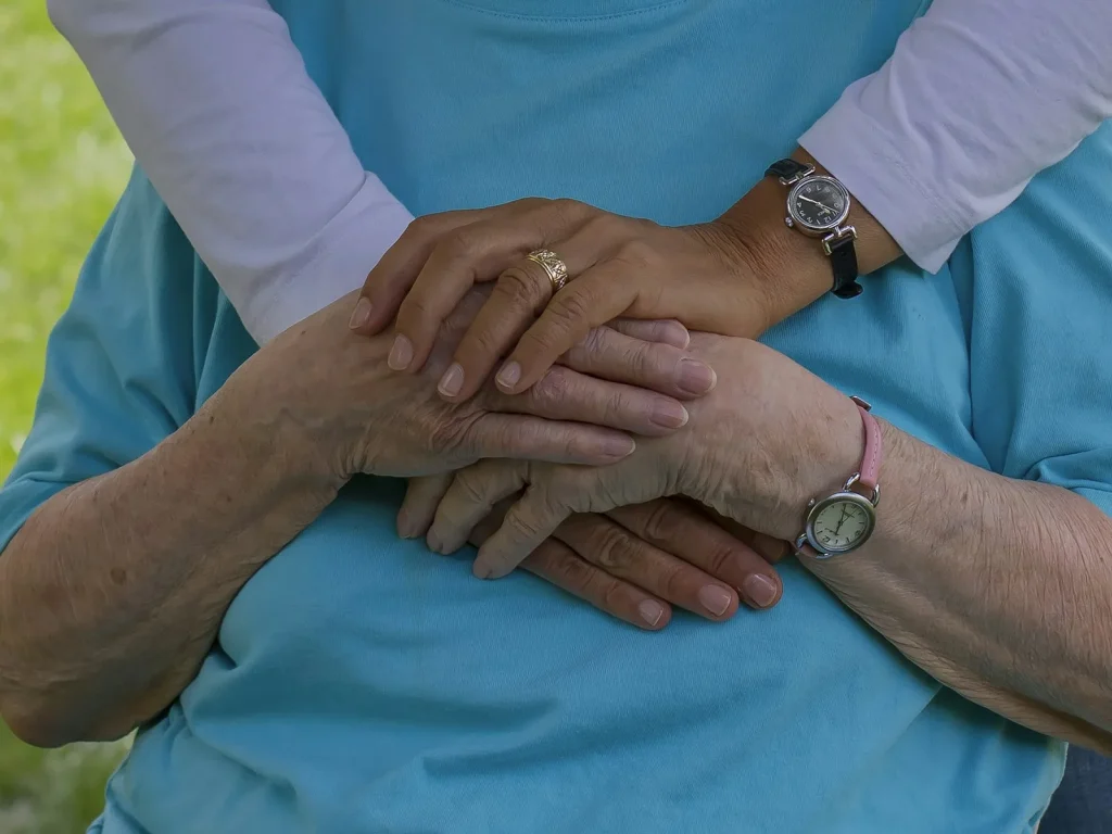 person wearing silver round analog watch