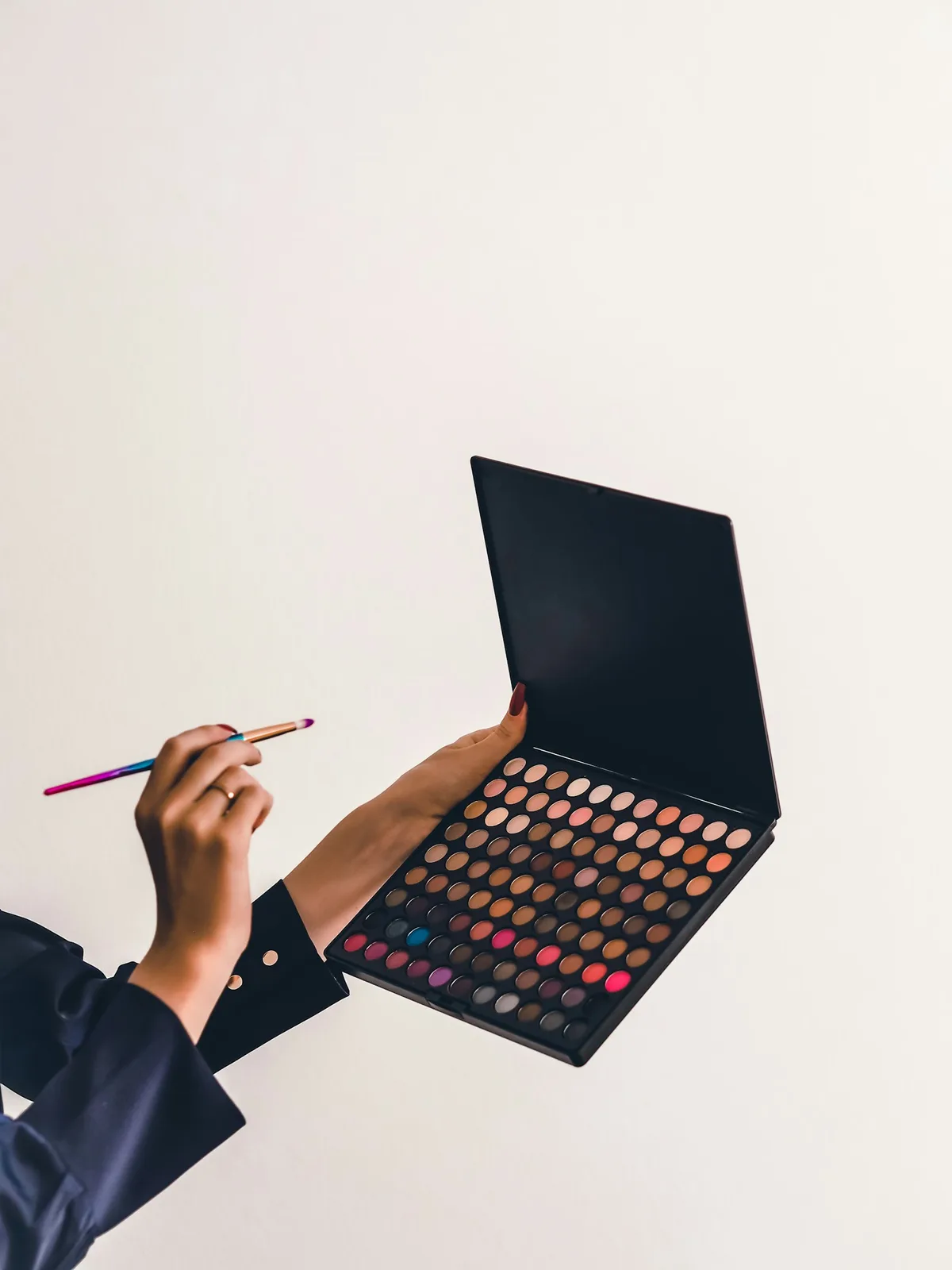 person holding makeup palette
